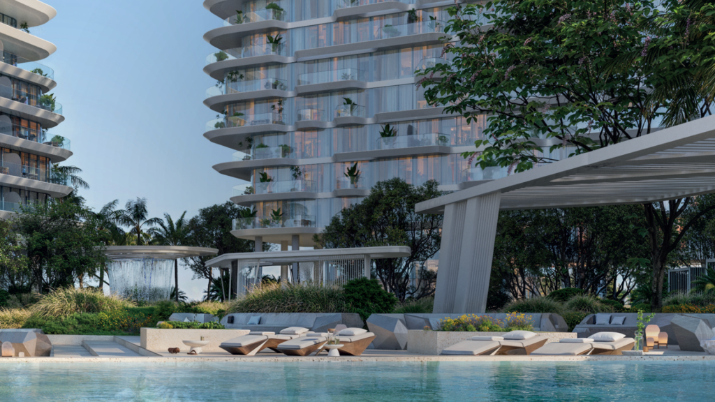 Modern luxury apartment buildings with curved balconies and greenery, overlooking a serene pool with sun loungers, shaded pergola, lush landscaping and water fountain in a tropical setting.