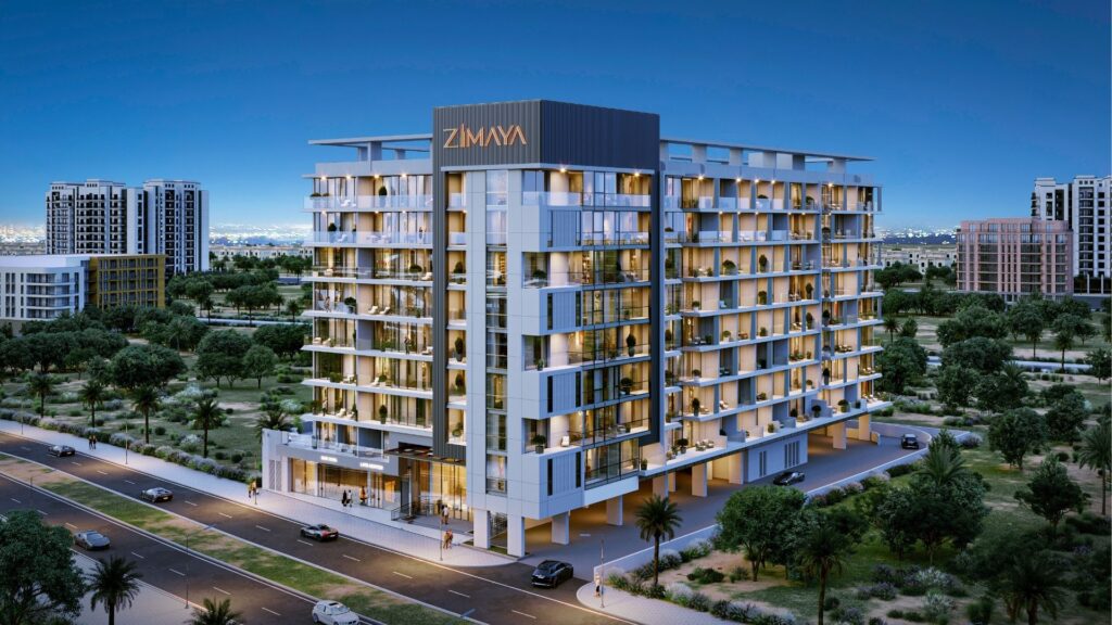 L'immeuble résidentiel moderne de moyenne hauteur "ZIMAYA" offre une belle vie avec ses balcons, ses grandes fenêtres et son éclairage du soir, dans une zone urbaine entourée de verdure, de routes et d'autres bâtiments en arrière-plan.