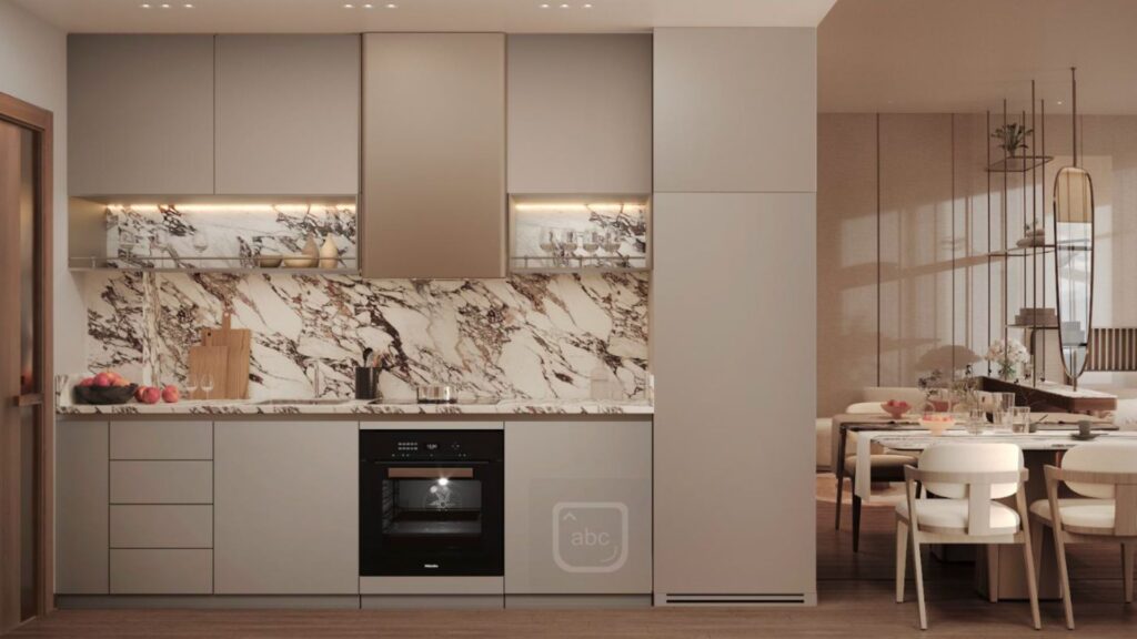 Modern kitchen with light gray cabinetry, marble backsplash, built-in oven and minimal appliances at Marquis One Arjan. The dining table with white chairs is visible on the right in this open living space.