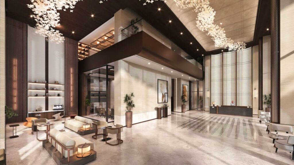The Marquis One Arjan Hotel's modern lobby, with its high ceilings, elegant seating, marble floors, decorative murals, lush plants and sculptural pendant lighting, includes a reception area and mezzanine.