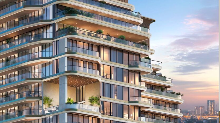 Marquis One Arjan, a modern multi-storey apartment building, features curved glass balconies, lush green plants and warm sunset lighting, overlooking a stunning cityscape and distant skyscrapers.