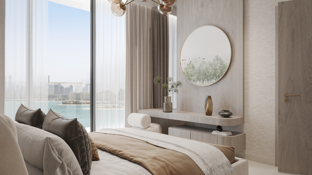 Un dormitorio moderno y minimalista con tonos neutros, una cama tamaño king, un espejo redondo sobre una elegante cómoda y ventanales que ofrecen vistas al agua y al lejano horizonte de la ciudad.