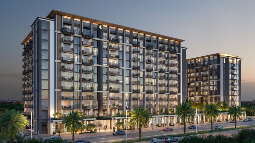 Immeubles modernes à plusieurs étages avec de grandes fenêtres et des balcons, illuminés au crépuscule. Des palmiers bordent la rue devant Windsor House de Ellington Properties, avec des voitures garées à proximité, créant une atmosphère urbaine haut de gamme.