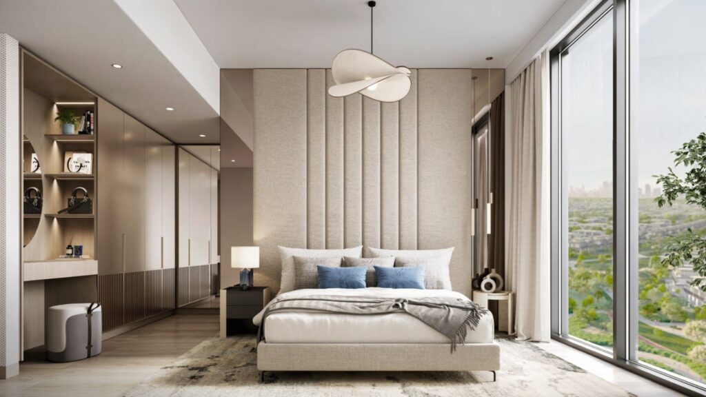 Chambre à coucher moderne à Windsor House de Ellington Properties comprenant un grand lit, une tête de lit beige rembourrée, des étagères encastrées, une armoire et des fenêtres allant du sol au plafond avec vue sur la ville. Les tons neutres créent une atmosphère calme et élégante.