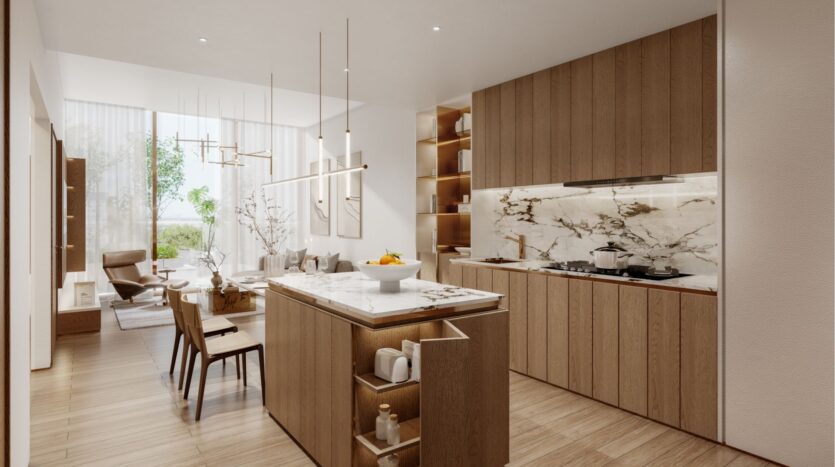 Cuisine et salle à manger modernes à Wynwood Horizon de Imtiaz avec des armoires en bois, des comptoirs en marbre et un décor minimaliste. Un îlot de cuisine aux lignes épurées accueille une coupe de fruits, éclairée par des lampes suspendues et par la lumière naturelle abondante provenant des grandes fenêtres.