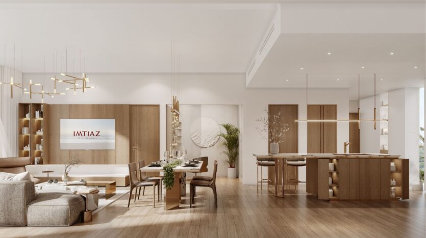 Spacieux salon et salle à manger modernes avec des tons neutres, des meubles en bois, un éclairage suspendu, un grand canapé, une table à manger, un îlot de cuisine et un décor minimaliste. Découvrez le Wynwood Horizon d'Imtiaz lorsque la télévision affiche "IAVTIAZ".