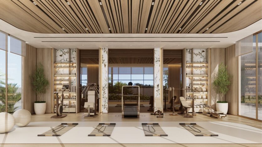 Salle de sport moderne et spacieuse à wynwood horizon de Imtiaz avec des accents en bois, de grandes fenêtres, des machines de fitness, des tapis de yoga, des ballons d'exercice et des étagères élégantes avec des plantes. La lumière naturelle remplit cet espace accueillant.