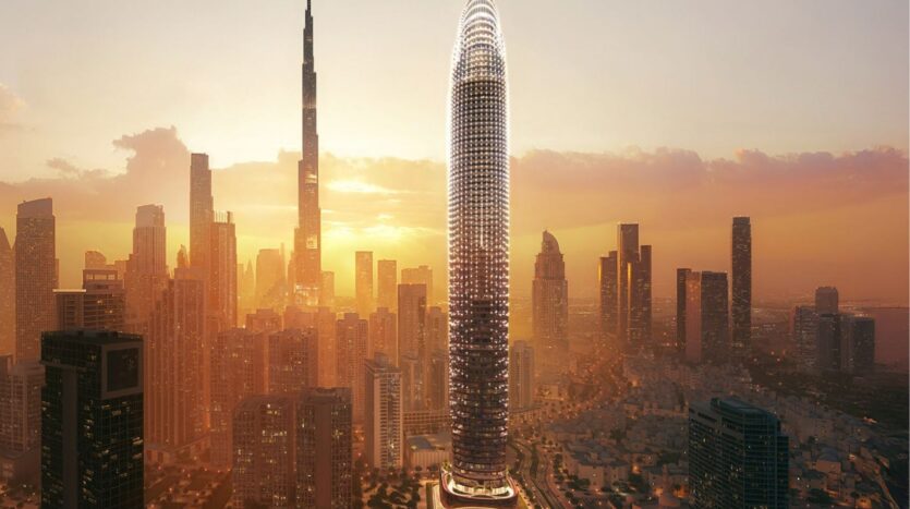 Un rascacielos futurista de forma ovalada, inspirado en el Skyblade de Binghatti, se eleva entre otros edificios altos en un paisaje urbano moderno al atardecer, la luz dorada proyecta un cálido resplandor sobre el horizonte.