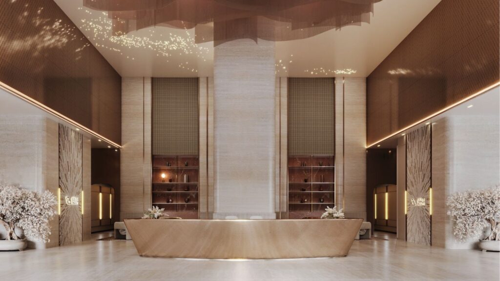 El lujoso vestíbulo del hotel, con su amplia recepción central, elegantes paredes de mármol beige e iluminación decorativa, marca el tono del Binghatti Skyblade. Las modernas estanterías y los arreglos florales crean un ambiente espacioso y sofisticado.