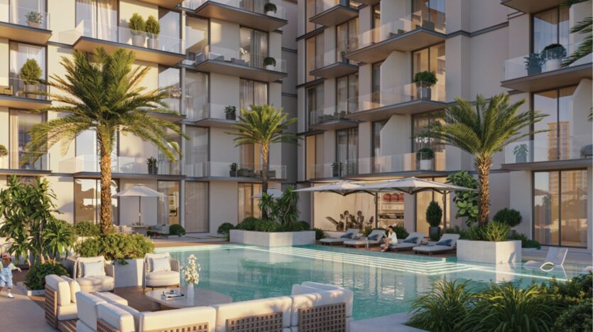 Ce complexe d'appartements modernes avec balcons donne sur une élégante piscine extérieure, entourée de palmiers, d'une végétation luxuriante, de chaises longues, de parasols et d'espaces confortables pour se détendre.