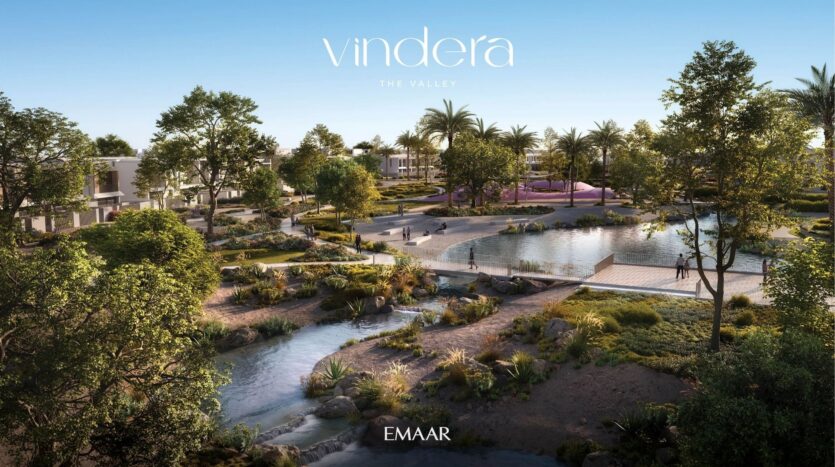 A tranquil residential community with modern villas, lush vegetation, walking paths, water features and palm trees, with the "Vindera The Valley" and "EMAAR" logos at the top and bottom of the image.