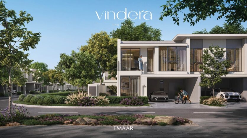 Modern villas with large windows, balconies and sleek design, surrounded by lush trees and greenery. Two cars parked in driveways; one person stands on a balcony while an adult and a child walk on the sidewalk. Text "Vendera" and "Emaar".