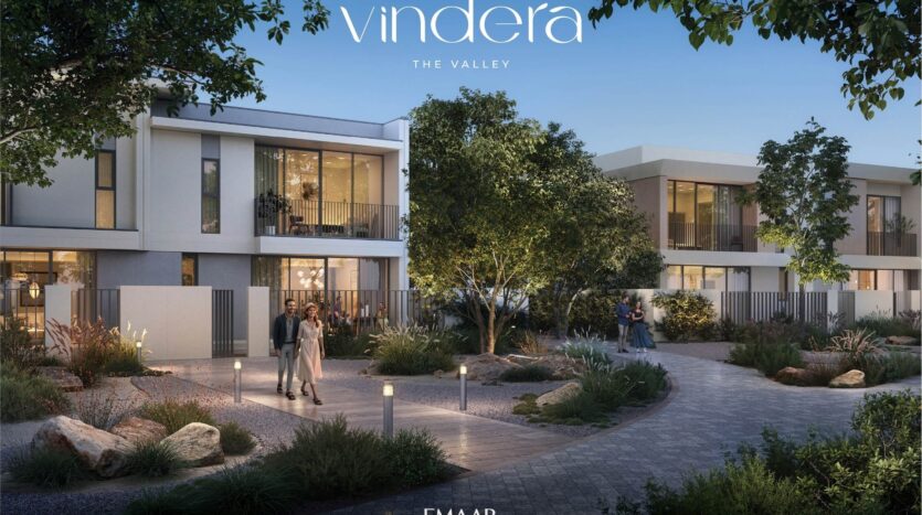 Modern residential buildings with large windows overlook a landscaped driveway with walkers, greenery, trees and outdoor lighting at dusk. The text "vendera THE VALLEY" appears at the top.