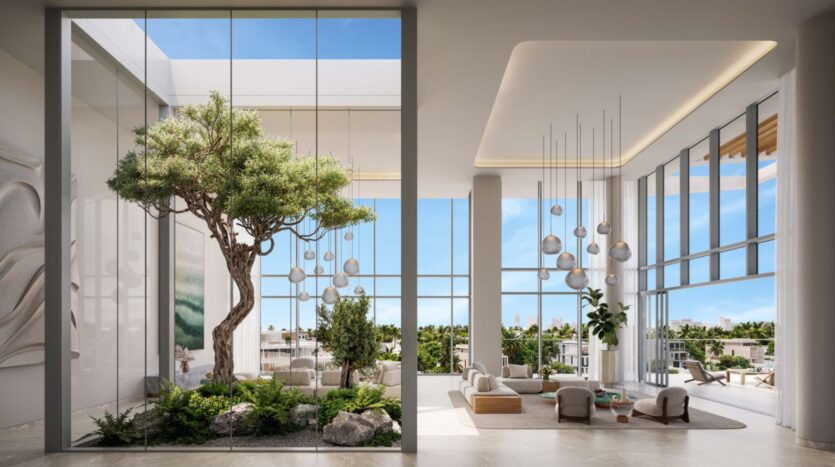 Современный и просторный лаундж Palm Central с окнами от пола до потолка, комнатными растениями, минималистичной мебелью и крытым садом с большим деревом создает светлую и воздушную атмосферу, наполненную естественным светом и зеленью.