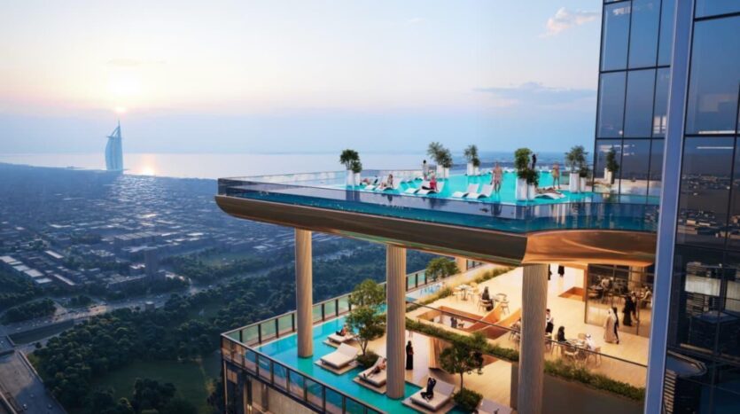 A luxury SkyParks rooftop pool and lounge, with lush greenery, crowns a skyscraper that overlooks the city and coastline at sunset; the iconic Burj Al Arab is visible in the distance.