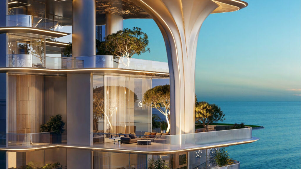 The modern luxury building Breez by Danube Maritime City, with its large windows, spacious terraces and greenery, overlooks a calm, blue sea at sunset. The architecture features soft, curving lines and trees integrated into the design.