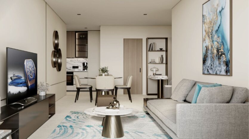 Un salon moderne avec un canapé gris, une table basse ronde, un tapis abstrait, un tableau mural et une télévision. Le style fait écho à l'élégance de Franck Muller Yachting à Dubai Maritime City - des tons neutres avec des accents bleus évoquent une ambiance côtière sereine.