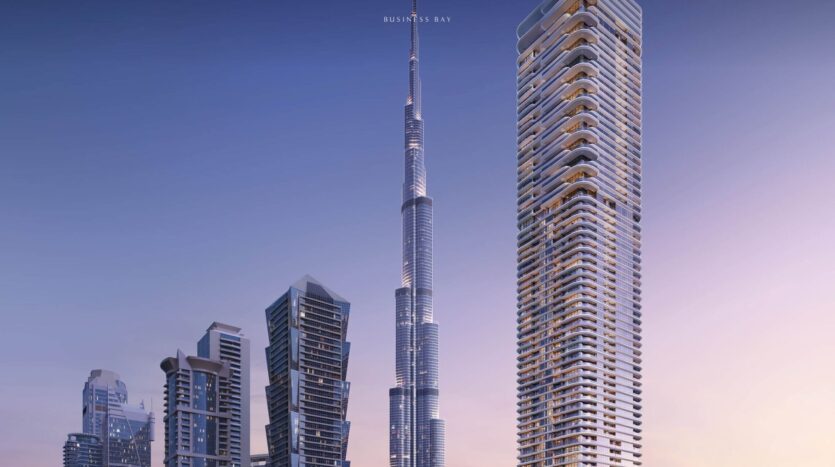 View of the modern skyscrapers of Business Bay in Dubai at sunset, with the Burj Khalifa and surrounding skyscrapers, the luxurious Avarra residences standing out against a clear blue and pink sky.