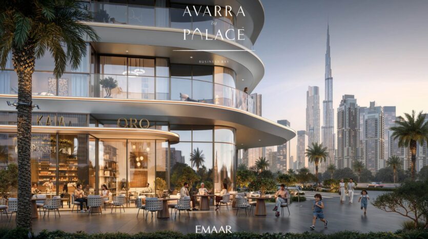 Modern open-air dining room in Avarra with people seated at tables in front of a curved glass building, palm trees and a panorama of the city with the Burj Khalifa; the text reads "Avarra by Palace, Business Bay, EMAAR.