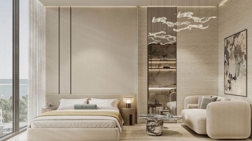 The modern, minimalist bedroom at Rabdan Gardens features neutral tones, a king-size bed, a cream sofa, abstract wall art, floor-to-ceiling windows with ocean views, and elegant ceiling-hung light fixtures.