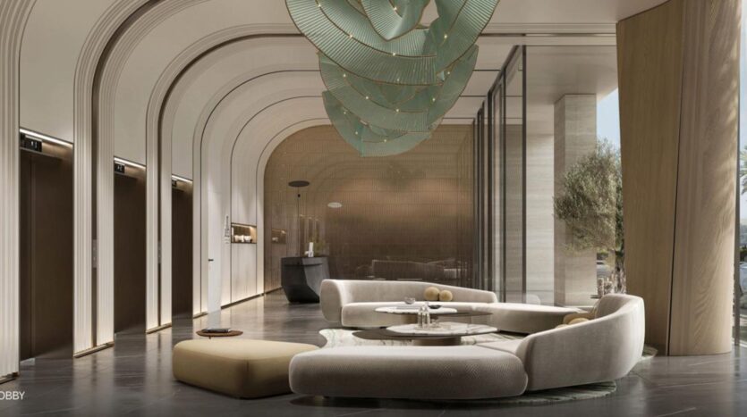 Modern Rabdan Gardens lobby with curved beige seating, round tables, arched walls, sculptural green chandelier and floor-to-ceiling windows. Three elevator doors line the left wall; reception is at the far end.