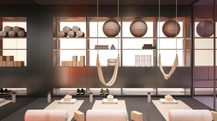 A modern yoga studio in Rabdan Gardens with hammocks, mats, yoga blocks and exercise balls neatly arranged on shelves. The space is clean, organized and lightly lit, creating a calm and inviting atmosphere for practice.