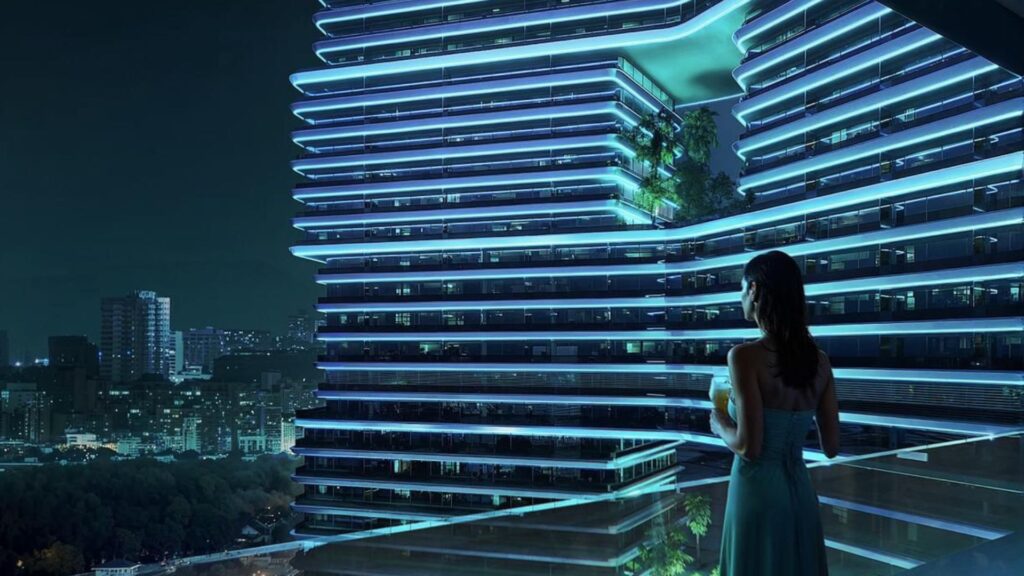 A woman in a blue dress stands on a balcony at night, gazing at a modern building with blue lights and Sky Terraces. City lights and trees sparkle in the background.