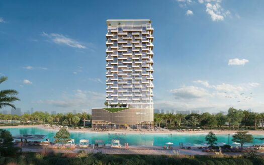 The Caden is a large modern tower with a unique geometric facade that stands on the edge of a large turquoise lagoon, surrounded by palm trees, sun loungers and landscaped gardens under a clear, luminous sky.