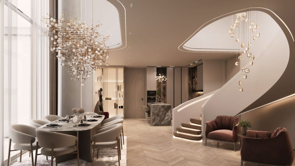 A sleek, modern dining and living room, The Symphony features a marble table, plush chairs, a sculptural chandelier, a grand staircase with gold accents and soft, neutral tones throughout.