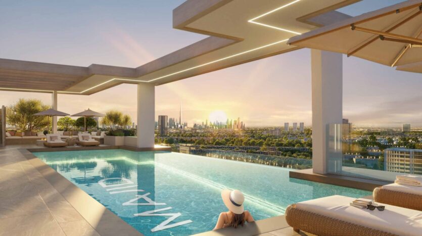 A person wearing a sun hat relaxes in a rooftop infinity pool at sunset, overlooking the skyline of modern Arlington Park 2, with lush greenery and elegant relaxation areas nearby.