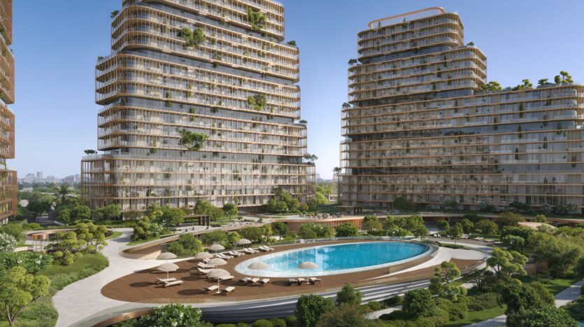 Modern, high-rise buildings, Hado-style, with curved edges, surround an oval pool and landscaped gardens featuring trees, plants, lounge chairs, and umbrellas, all under a clear blue sky.