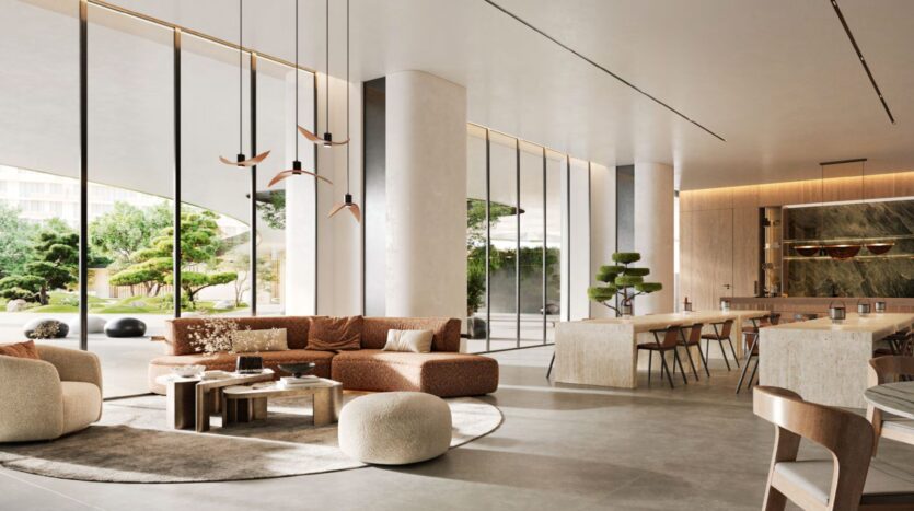 Spacious, modern lounge with floor-to-ceiling windows, beige and brown furniture, round coffee tables, sculptural lighting, and an elegant Hado bar. Large plants are visible inside and outside through the windows.