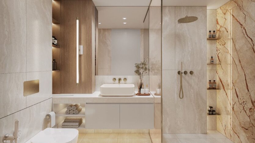 Modern bathroom with beige marble walls, Holm One floating vanity with sink, large backlit mirror, walk-in shower with glass partition, built-in shelves for towels and toiletries, and minimalist toilet.