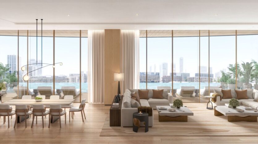 The Edition's modern and spacious living and dining room, with large floor-to-ceiling windows, neutral décor, light wood flooring, elegant furnishings, and breathtaking views of the city in the background.