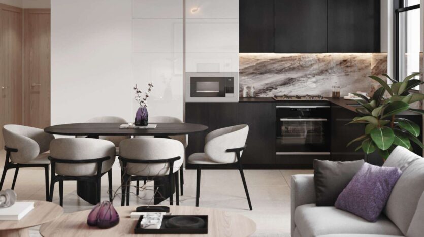 Modern Alta View kitchen and dining room with dark cabinets, marble backsplash, built-in appliances, black oval dining table with six light-colored chairs, and a nearby sofa with purple cushions and a green plant.
