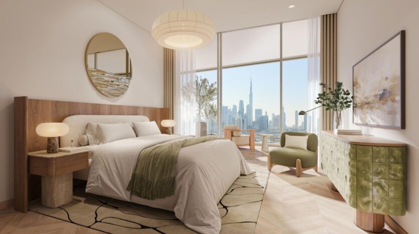 A modern bedroom with a large bed, wooden furniture, and neutral décor showcases refined art. Floor-to-ceiling windows offer views of the city skyline, including a large skyscraper. Soft lighting and minimalist artwork create a comfortable and elegant atmosphere.