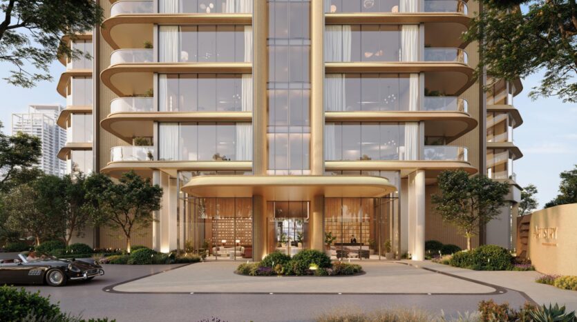 The image shows the entrance to a modern, luxurious apartment building with large bay windows, gold accents, greenery, and curved balconies. A vintage car is parked on the left side of the driveway, highlighting the artistic nature of every detail.
