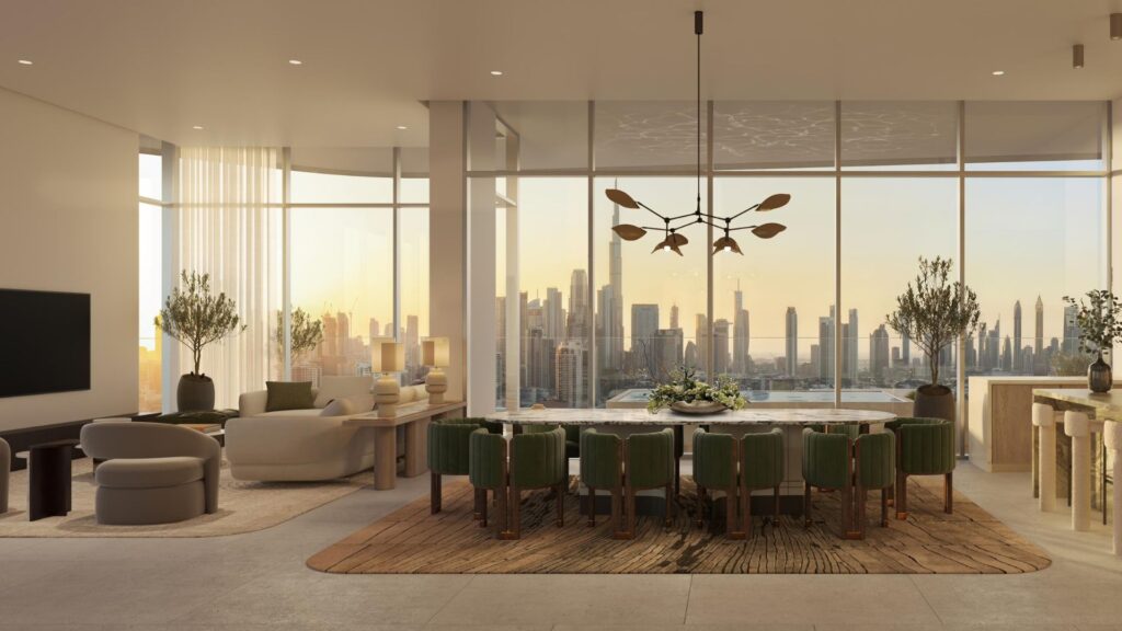Modern and elegant living and dining room, open to the outside and featuring large windows offering breathtaking views of the city at sunset. The space includes green chairs, a marble dining table, comfortable seating, and décor that highlights the art throughout the space.