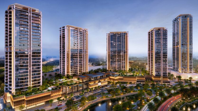 Eltiera Views is a modern urban complex consisting of five tall residential towers clad in glass, overlooking a landscaped area with palm trees, water features, and podium buildings connected at sunset.