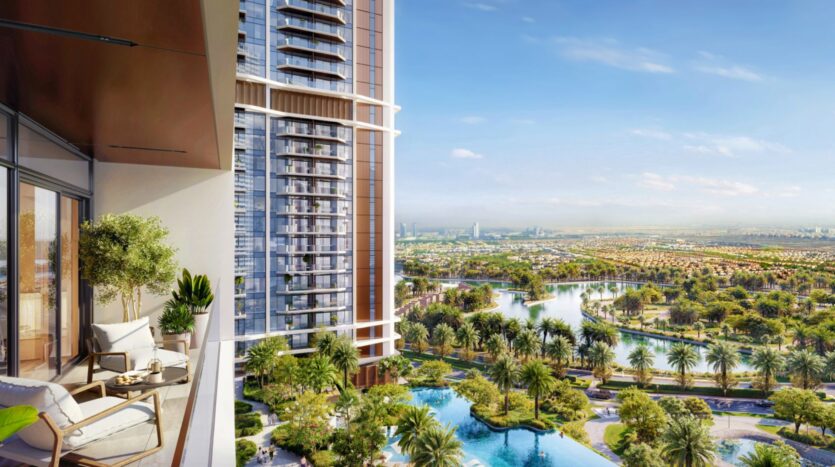 The balcony of a modern building, furnished with chairs and plants, overlooks lush gardens, palm trees, a swimming pool, and the magnificent urban landscape of Eltiera Views under a clear blue sky.