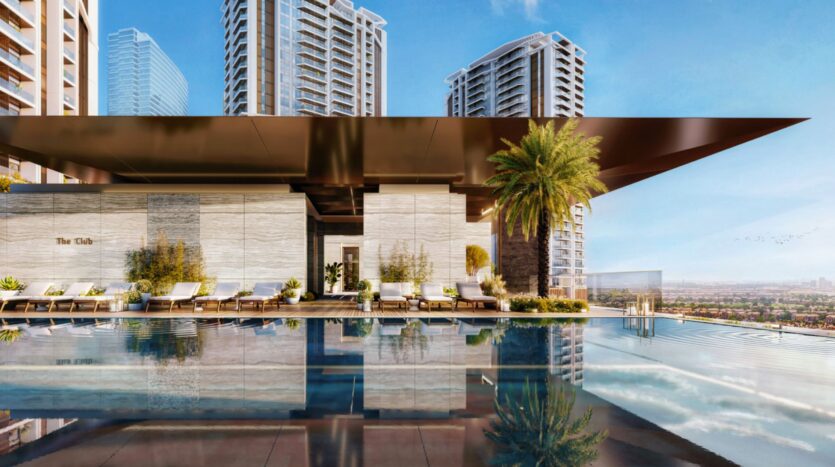 A modern rooftop pool with sun loungers, a palm tree, and city views, surrounded by tall skyscrapers under a clear blue sky, perfect for enjoying the breathtaking views of the Eltiera.