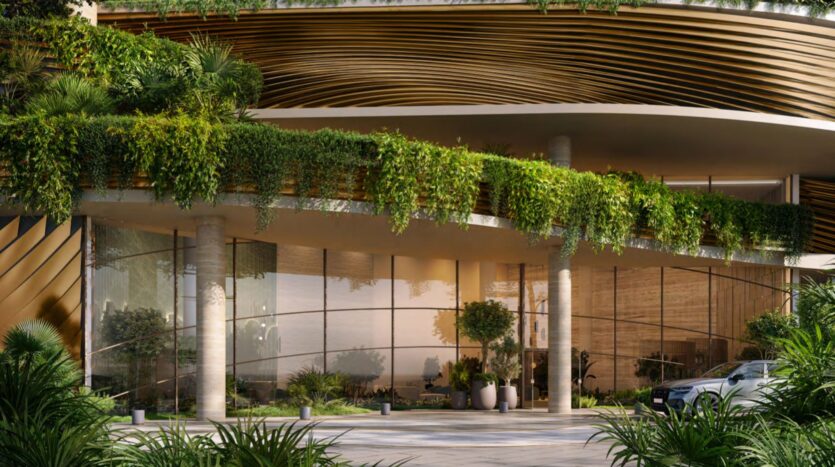 A modern building inspired by Kanyon, with large bay windows, greenery and plants cascading from the upper balconies, golden and curved architectural elements, and potted plants near the entrance.