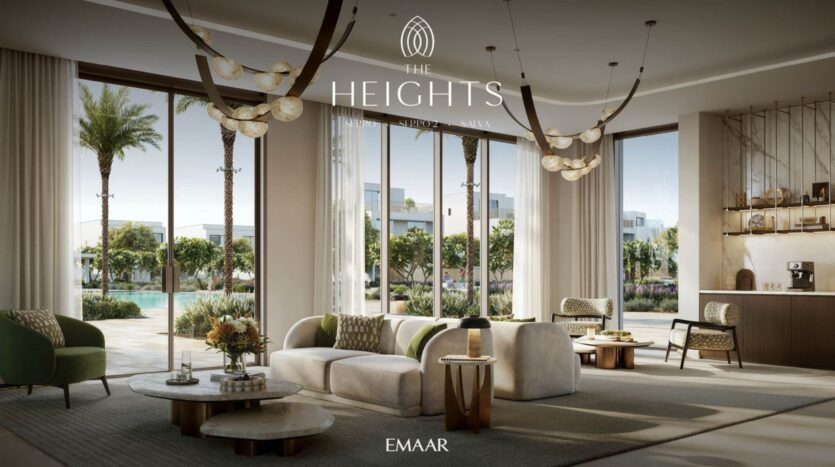 A modern and elegant living room in The Heights with large windows overlooking a pool and palm trees. The space features neutral-toned sofas, armchairs, coffee tables, pendant lights, and a stylish coffee station.