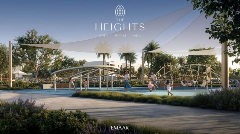Children and adults enjoy a modern playground with climbing structures and shade sails, surrounded by greenery and palm trees in The Heights residential community. The "The Heights" and "EMAAR" logos are displayed at the top and bottom.