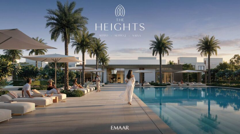 A woman in a white dress walks by a luxurious pool at The Heights, surrounded by lounge chairs, palm trees, and modern buildings, with people relaxing under umbrellas; the logos "The Heights" and "EMAAR" appear above.