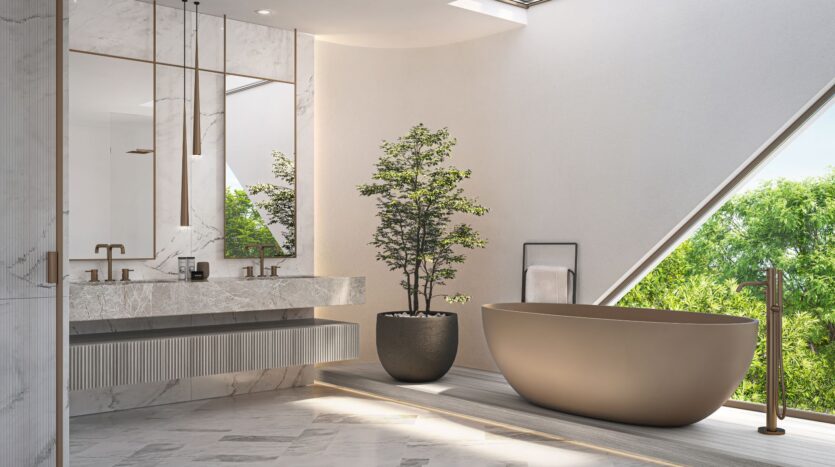 A modern bathroom with a freestanding bathtub by Bella by Passo, a large potted plant, a double-sink marble vanity, and large mirrors. Natural light streams in through a triangular window, highlighting the green trees outside.