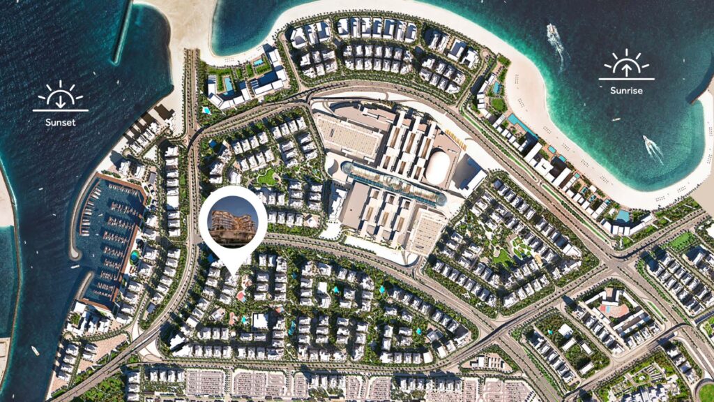 Satellite view of Flora Bay, a coastal town with beaches, curved roads, buildings, and a marina. Icons indicate the directions of sunrise and sunset. A pin highlights a specific building near the center.