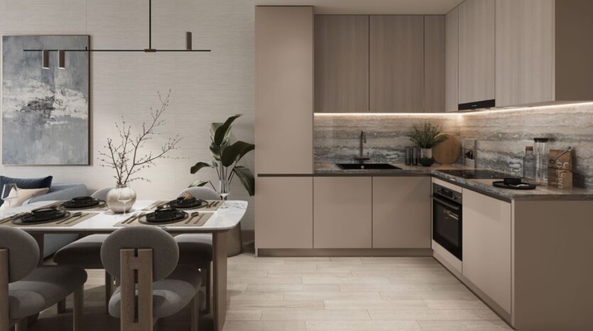 Modern kitchen and dining room in the Inara residence, featuring neutral tones, a marble table for four, beige cabinets, a built-in oven, minimalist decor, abstract wall art, and a large potted plant in the corner.