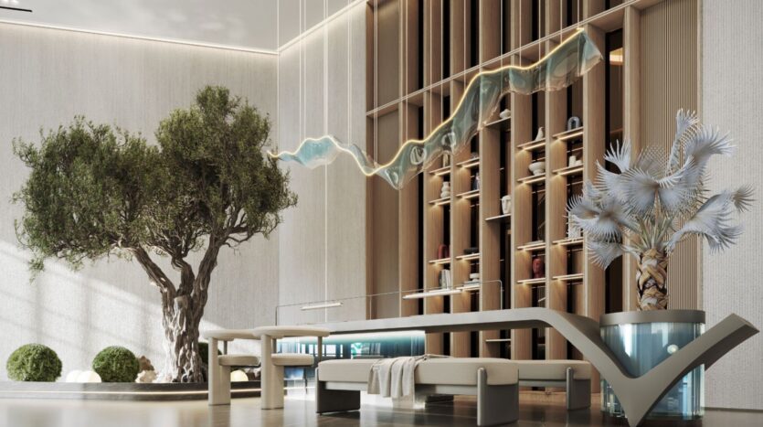 The modern and minimalist entrance hall of the Inara residence features a large tree, a sculptural light fixture, elegant benches, a wall of decorative shelves, and a potted plant, all in neutral tones and natural materials.