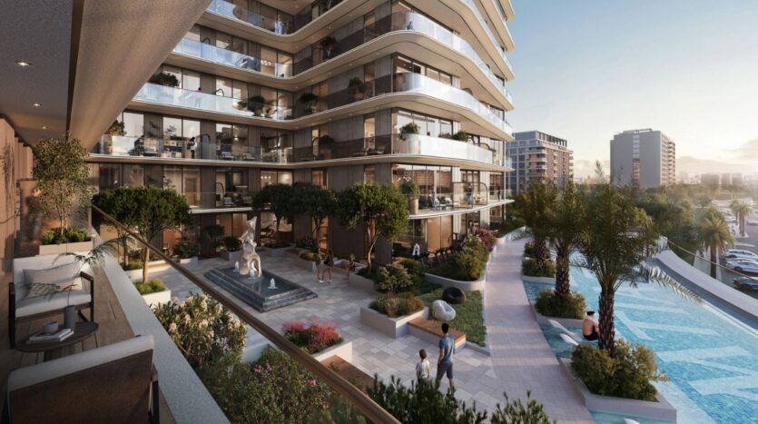 Modern apartment complex at the Inara residence with curved balconies, lush gardens, a fountain, a swimming pool, and people relaxing outdoors at sunset. The city's buildings form the backdrop to this lively scene.
